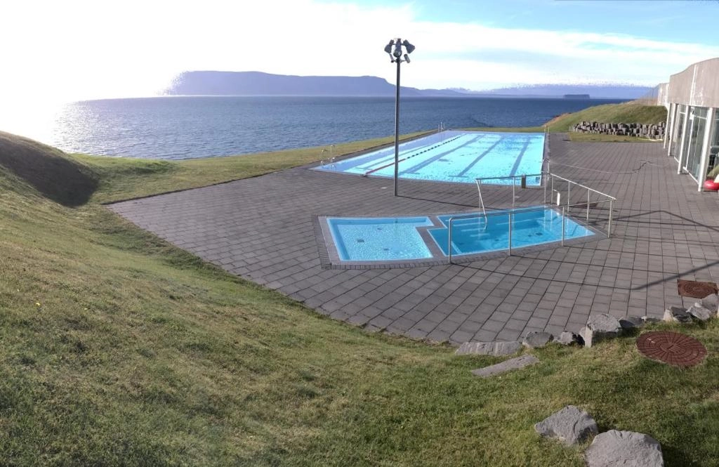 Coastal view at Lónkot with geothermal pool